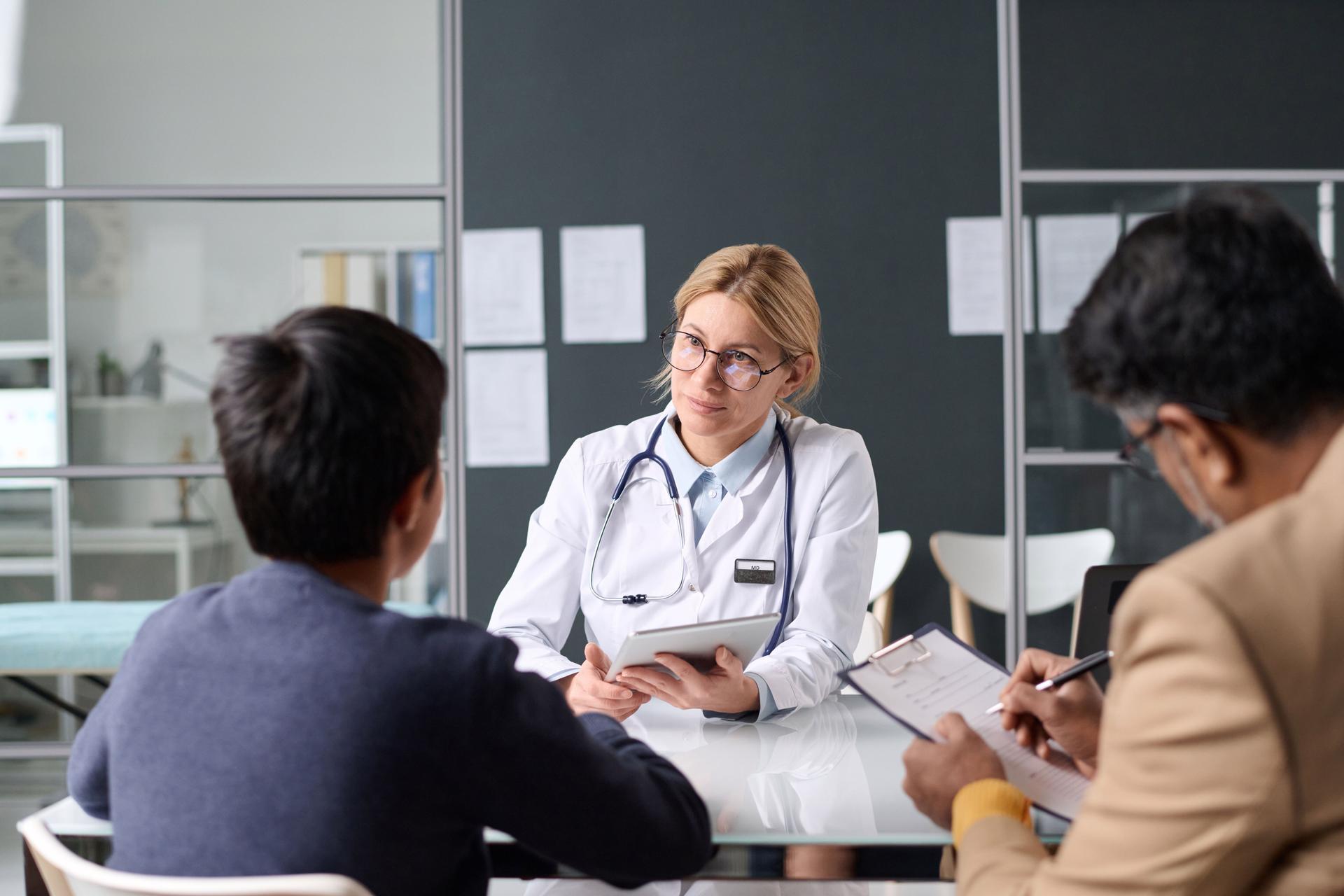 Female Doctor Consulting Middle Eastern Family